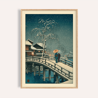 Framed Hasui Kawase snow print of a snowy bridge with two people and a weeping tree