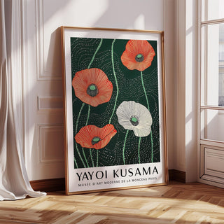 Print leaning on a wooden floor with red and white poppies against a dark green background and natural light