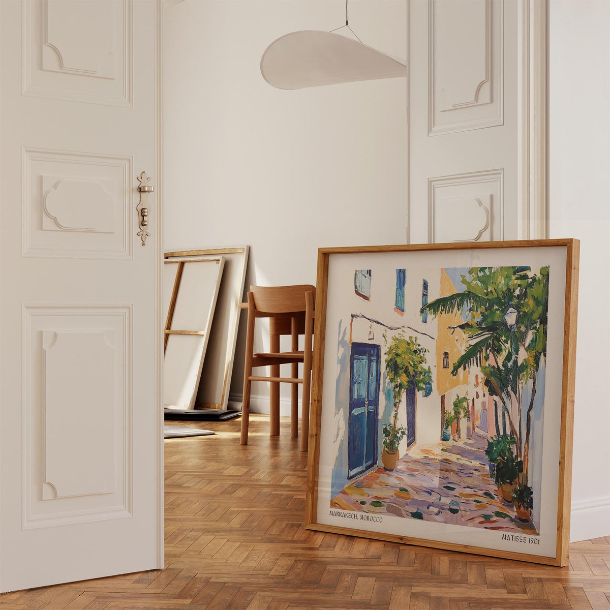 Morocco wall art leaning on the floor showing a Mediterranean street scene with trees in a light room
