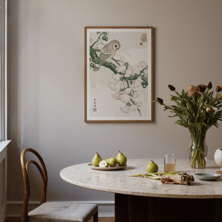 Owl Art Print in Japanese woodblock style with pink and green hues above dining table with fruit bowl