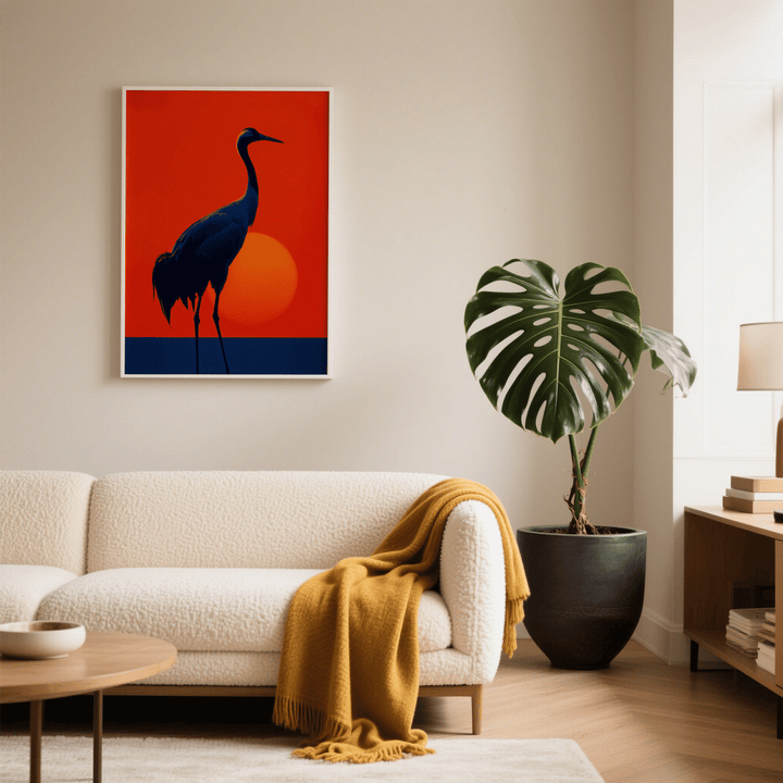 Cranes Silhouette Art Print on a wall above a sofa with a yellow throw and large leafed plant