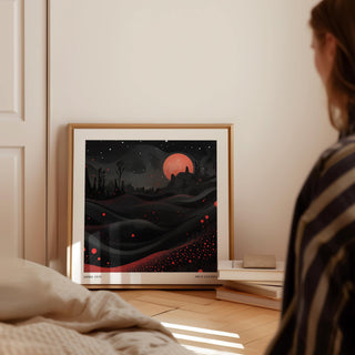 Wall Moon Art print leaning on the floor by a book stack in soft daylight