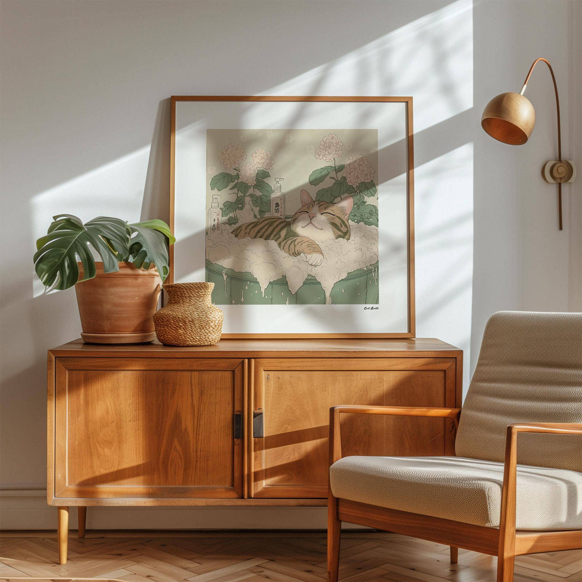 Framed Whisker Bath Bliss illustration of a tabby cat in a bubble bath in beige and green hues on a wooden sideboard