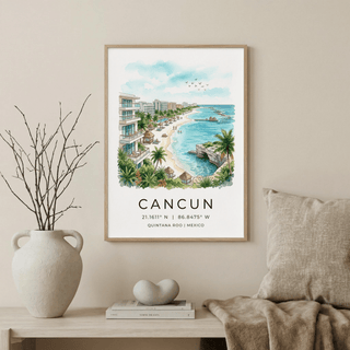Framed Cancun Beach art print in watercolour style above a shelf with books and a vase
