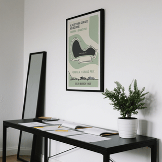 Melbourne Park Circuit Poster framed print close-up with green, beige and black in a room with a plant on a black table