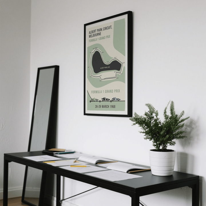 Melbourne Park Circuit Poster framed print close-up with green, beige and black in a room with a plant on a black table