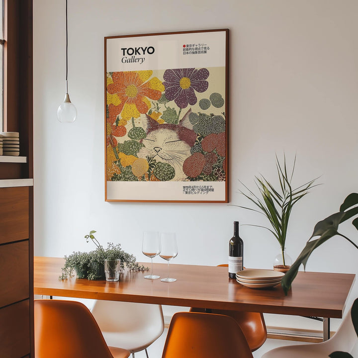 Japanese artwork print of a sleeping cat in colourful flowers in a dining room above a wooden table