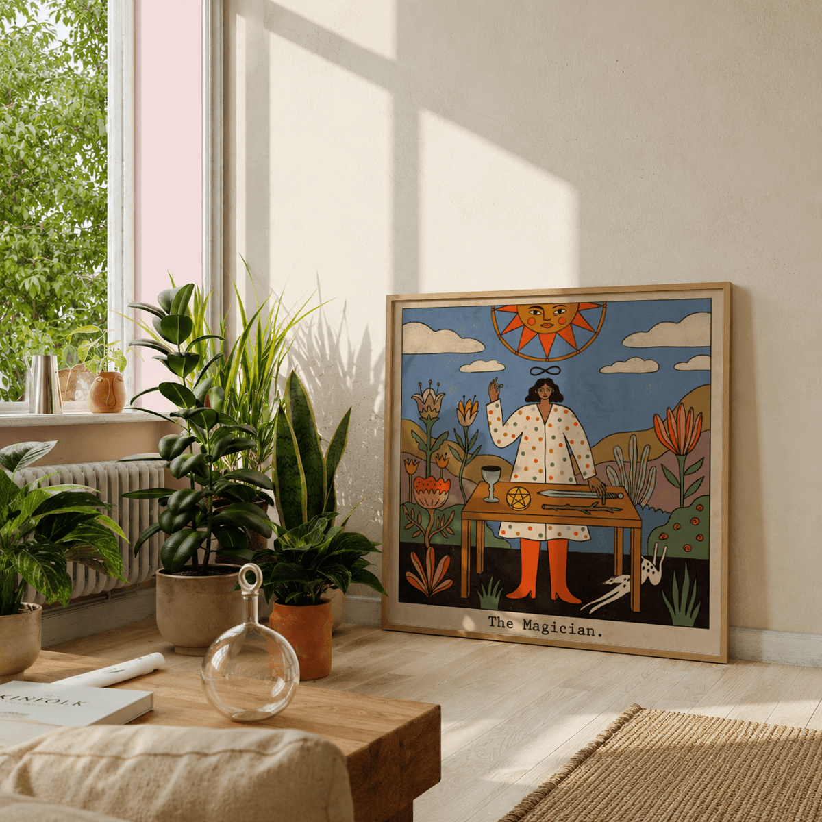 Tarot Magician wall art leaning against a wall with sunlight and plants nearby in a bright room