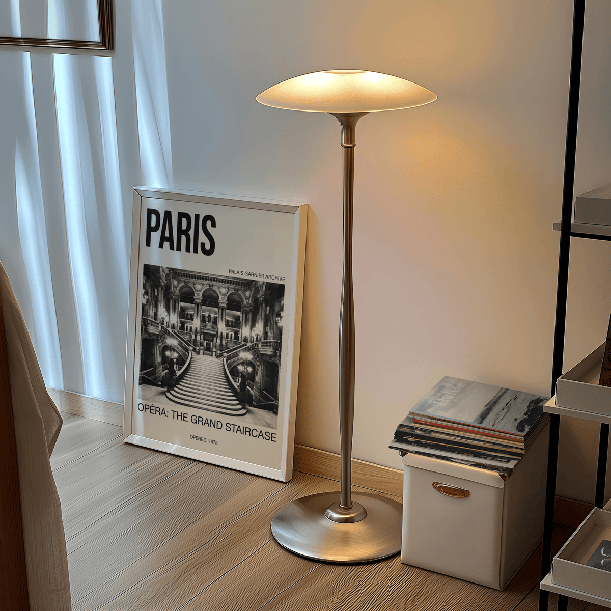 Print leaning on the floor of Paris Opera Art Print with a grand staircase in black and white beside a tall lamp