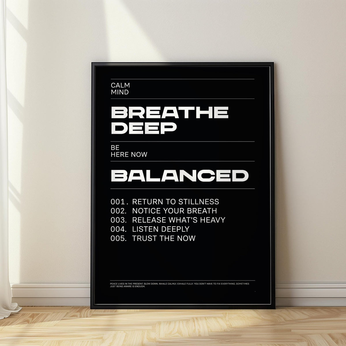 Phrases for Wall Art leaning typographic print with white text on black and sunlight on wooden floor
