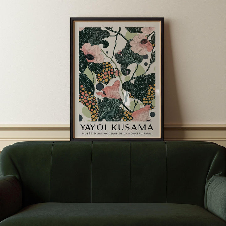 Wall Art with Pink Flowers framed print with pink flowers and dark green leaves above a green velvet sofa