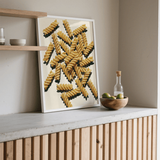 Fusilli Pasta Art print leaning on a kitchen worktop with a wooden bowl of fruit nearby