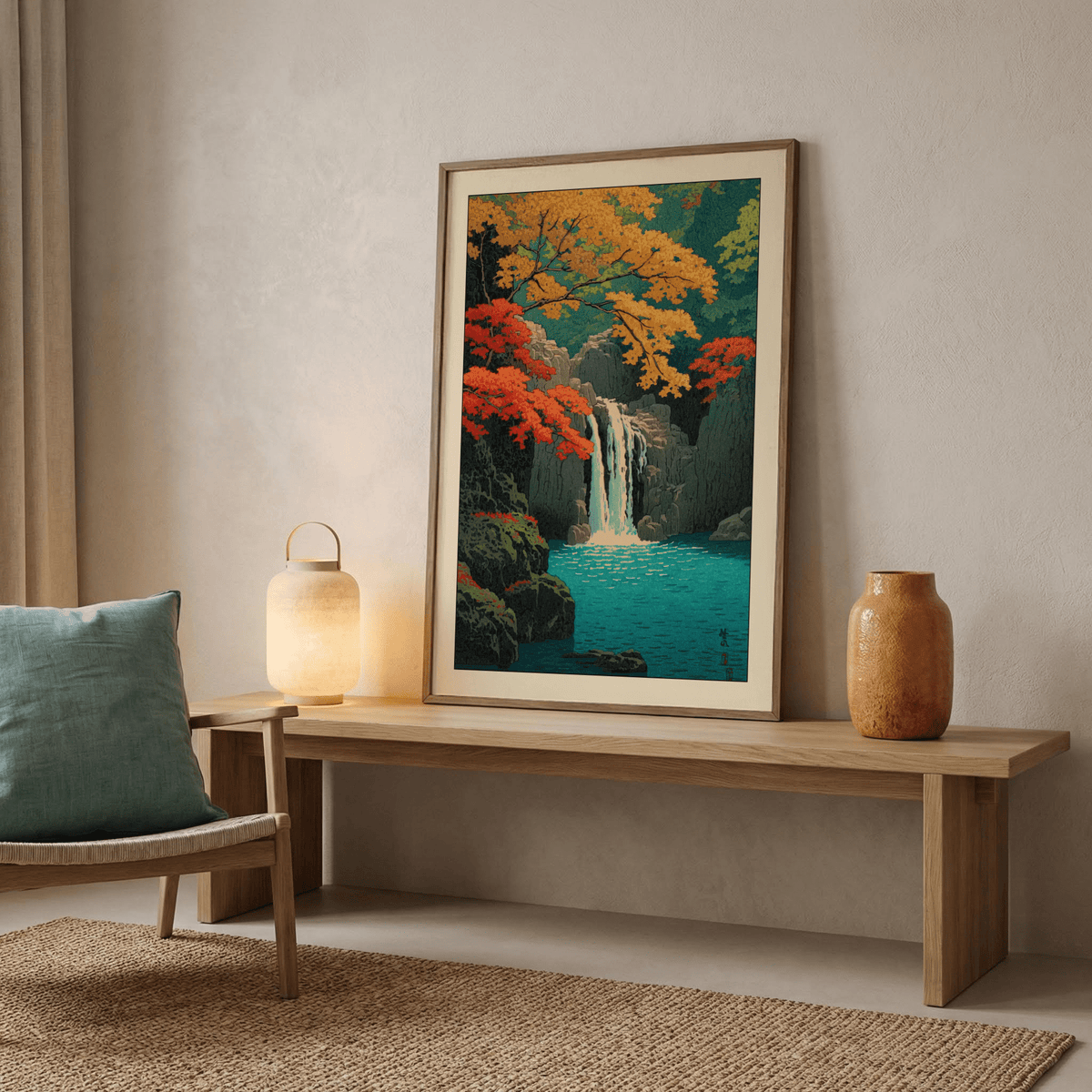 Print leaning on a wooden bench of a waterfall with autumn leaves and blue water with a lamp nearby