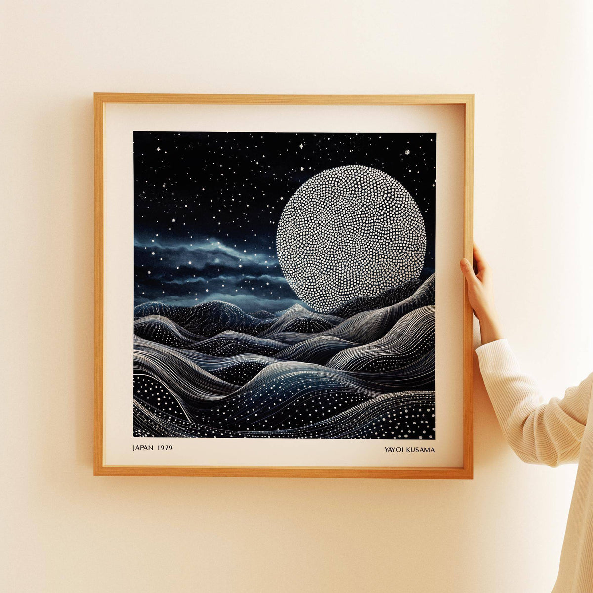 Unique wall art for bedroom with moon featuring dotted pattern and wavy abstract hills held by hand
