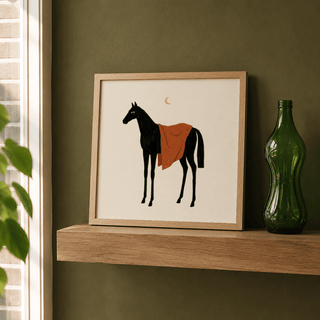 Framed Horse Moon wall art of a black horse with an orange blanket leaning on a wooden shelf next to a green bottle