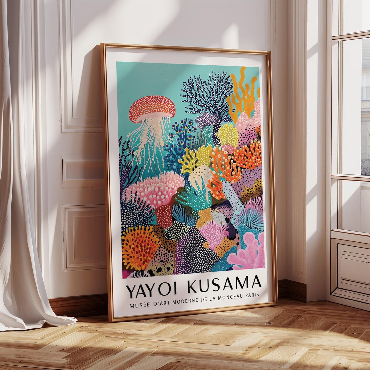 Print leaning on a floor of coral reef art with a pink jellyfish and colourful coral in natural light