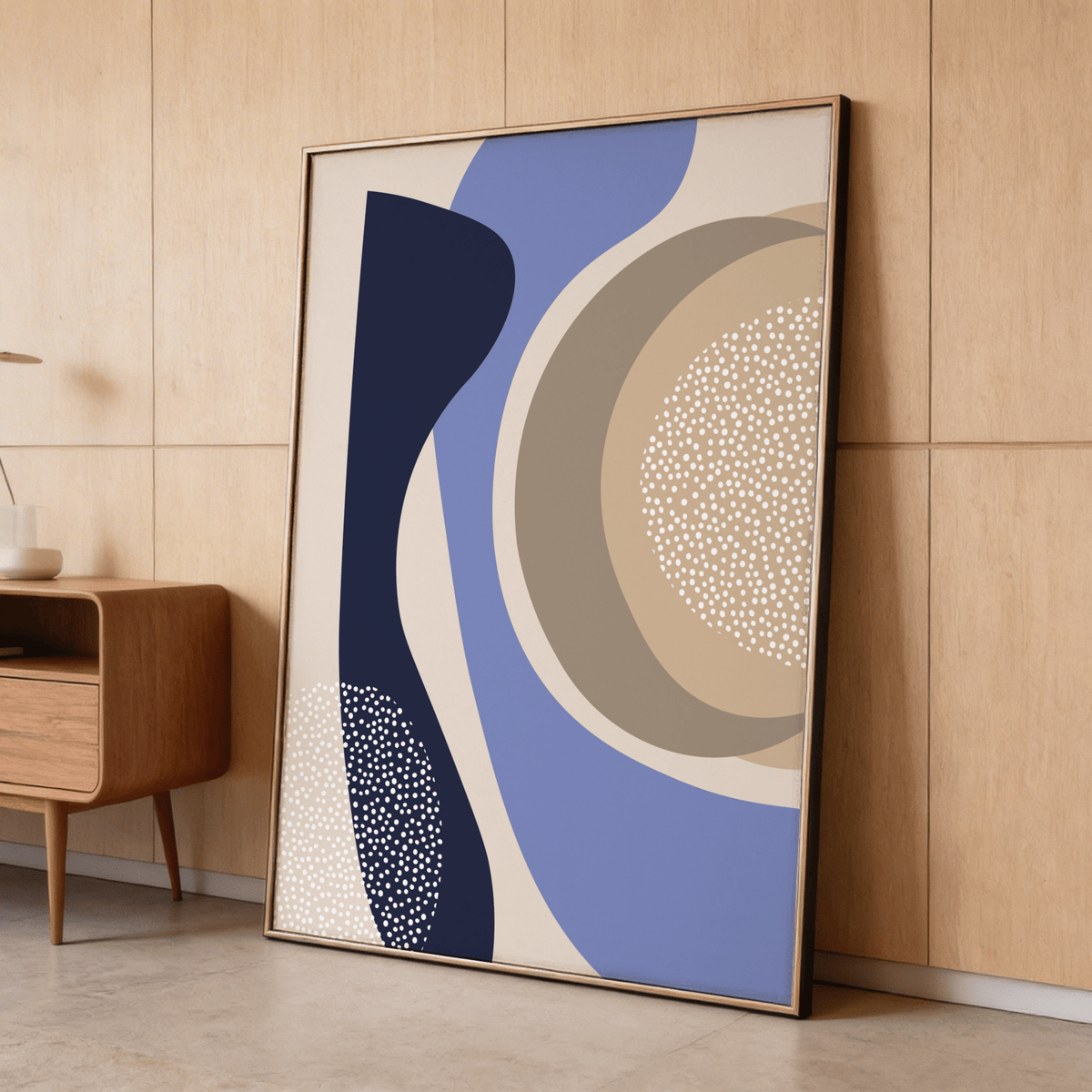 Modern Poster Design print leaning against a wood wall with a mid-century cabinet nearby