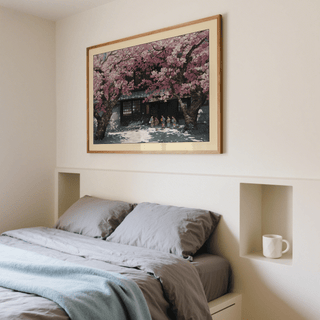 Print on a wall of Hasui Kawase Cherry Blossoms showing children under pink blossom trees above a bed with grey bedding