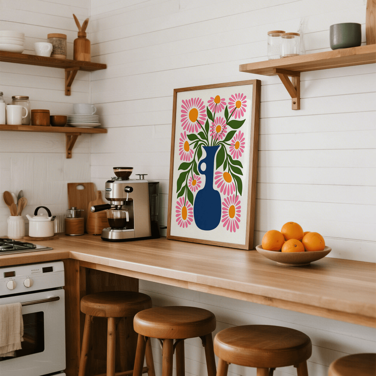 Flower Vase Print print leaning on a kitchen counter with wooden stools and a bowl of oranges