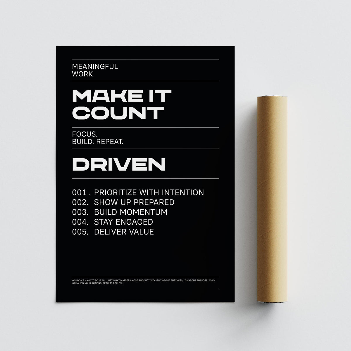 Motivational typographic poster with white text on black beside a brown packaging tube