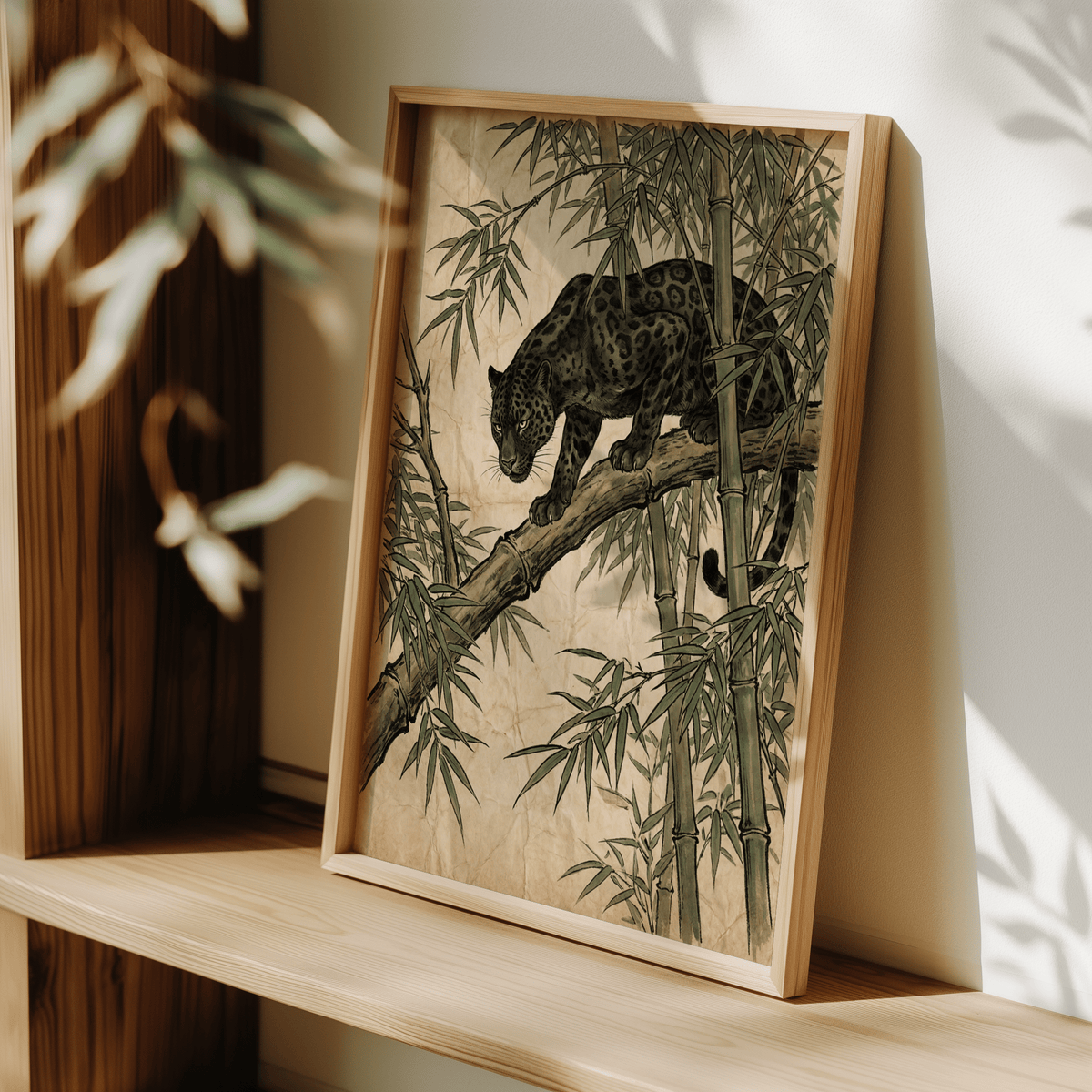 Framed Black Panther wall art leaning on a shelf with green bamboo and a black panther in brown tones