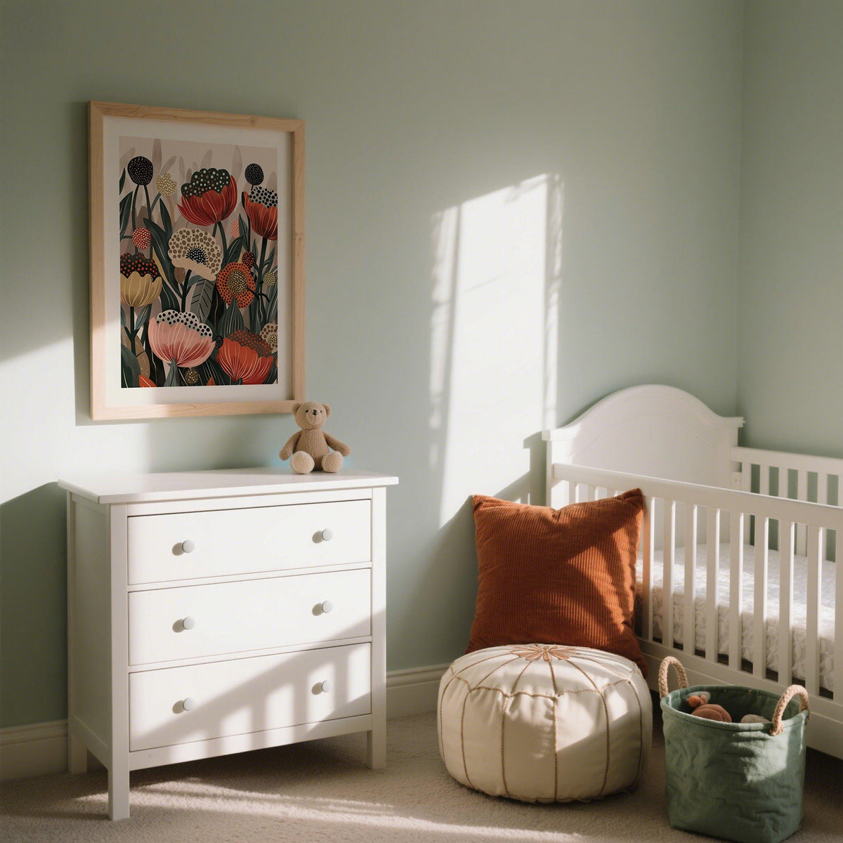 Art with Poppies framed print of stylised flowers in reds and greens above white chest of drawers in a nursery