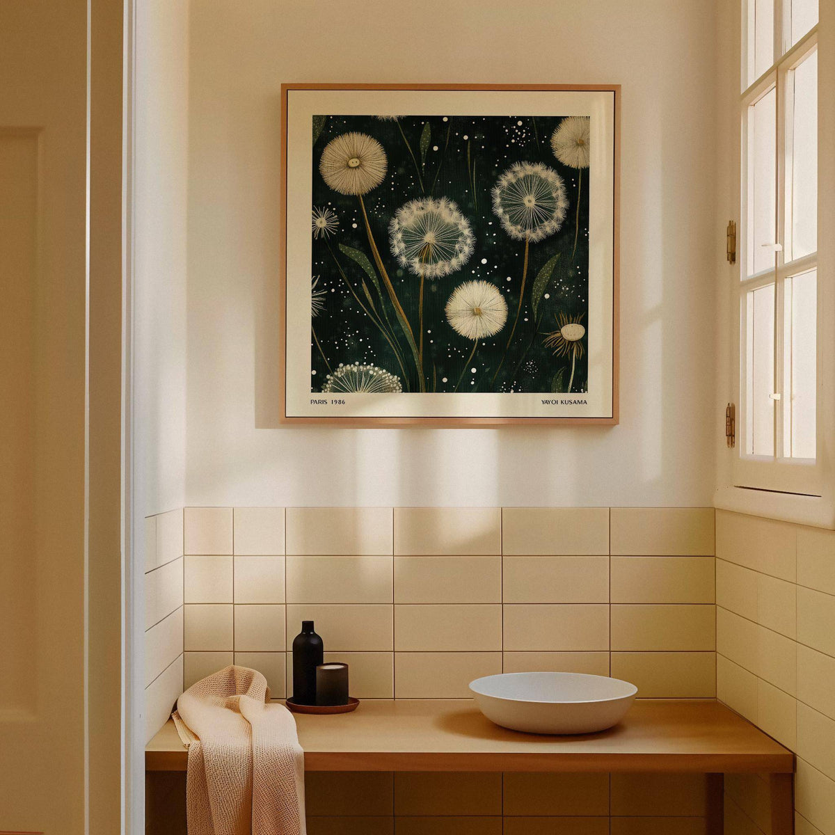 Square wall art of white dandelion seed heads in an illustration style in a bright bathroom above a wooden sink