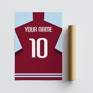 Custom football shirt poster in plain claret with white number lying flat next to a packaging tube