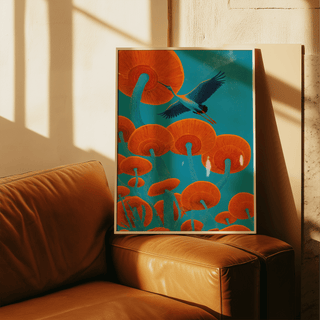 Japandi Bird Print leaning on a brown leather sofa with vivid orange mushrooms and blue background