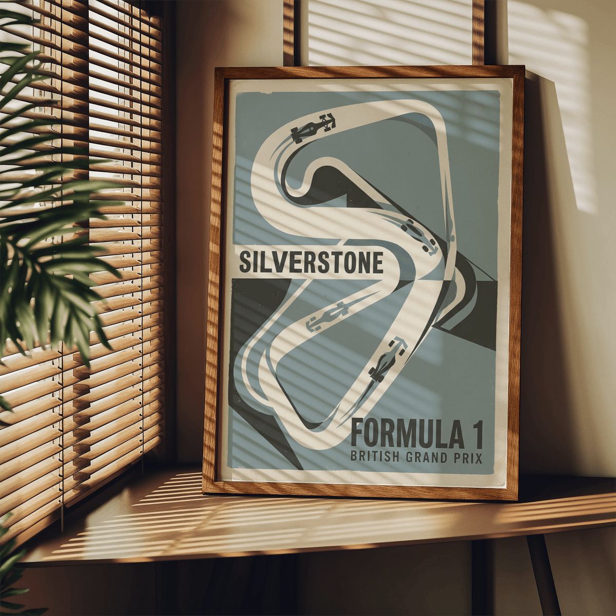 Framed British Race Track Map Poster Silverstone circuit map with blue and grey retro style on a wooden shelf