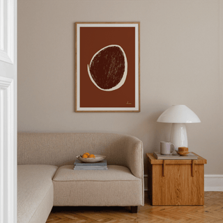 Abstract Earth Tone Art Print of a brown and cream shape above a beige sofa with a wooden side table in a living room