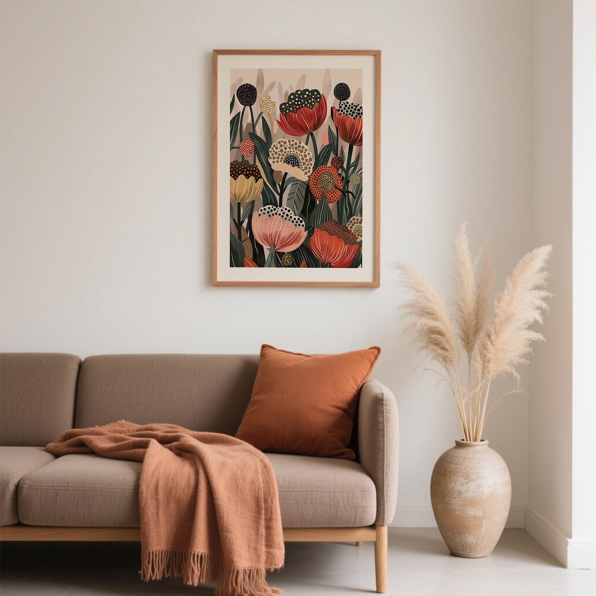 Art with Poppies framed print with stylised orange and beige flowers above a sofa with brown cushions