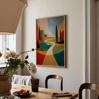 Colorful Golfing wall art with abstract shapes in orange green and blue above a wooden dining table with flowers