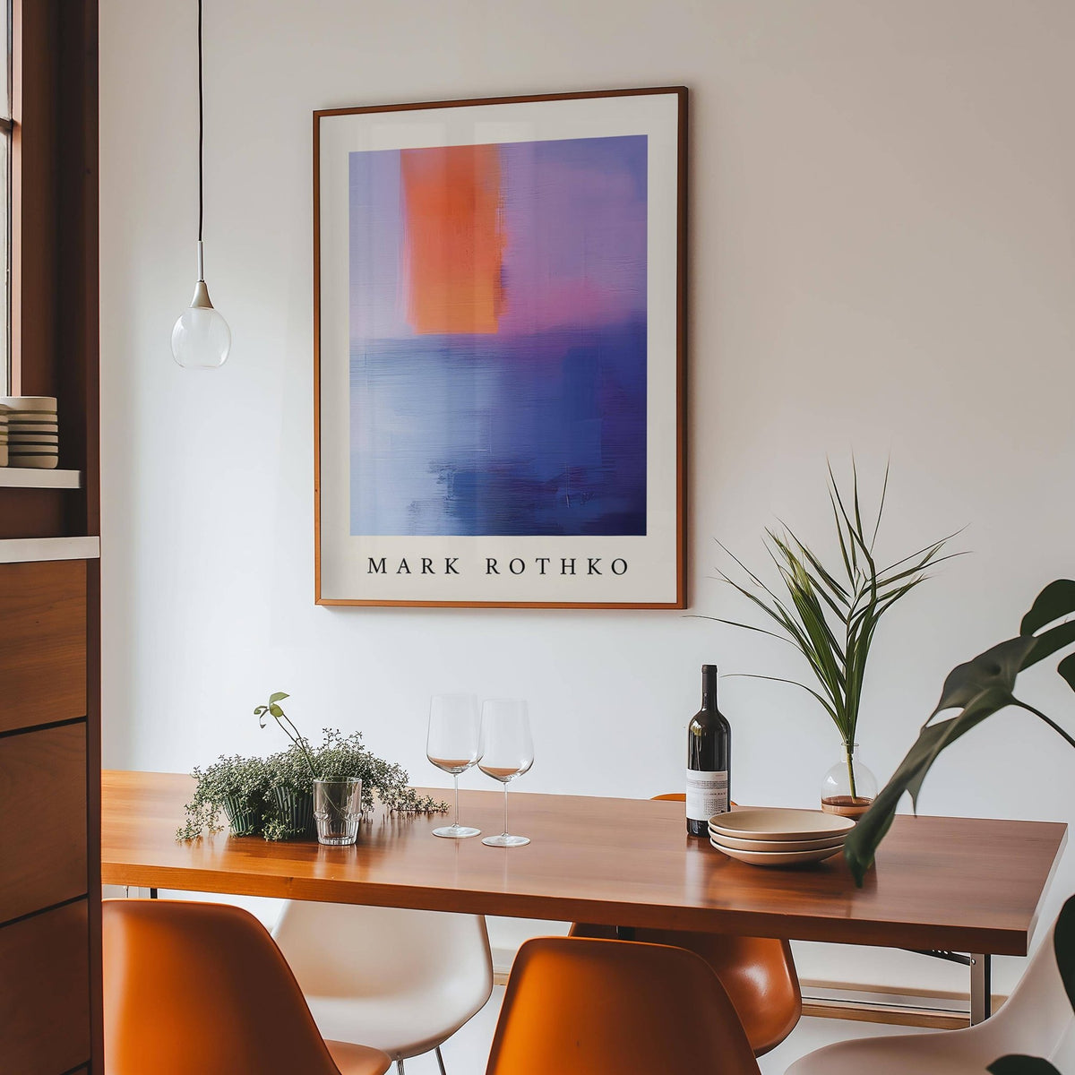 Rothko Art framed print of abstract colour blocks with orange above blue in dining room with plant on table