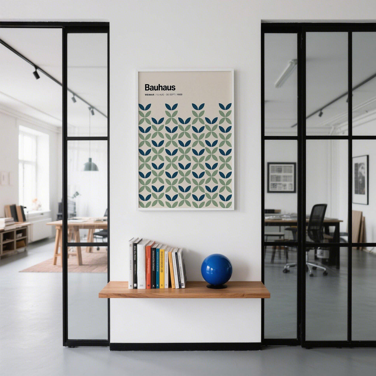 Blue and Green Wall Art with geometric leaf pattern above a shelf with books and a blue globe in office space