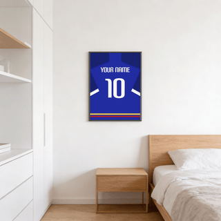 Football Shirt Poster in Blue with White Sleeve Stripe above a wooden bedside table in a bedroom