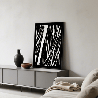 Art Black White Abstract print leaning on a grey sideboard beside a black vase and bowl in a living room