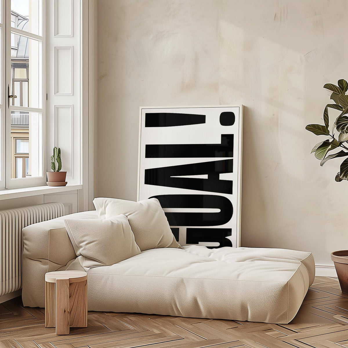 Wall Art for Games Room leaning large typographic print in black and white beside a beige sofa and plant