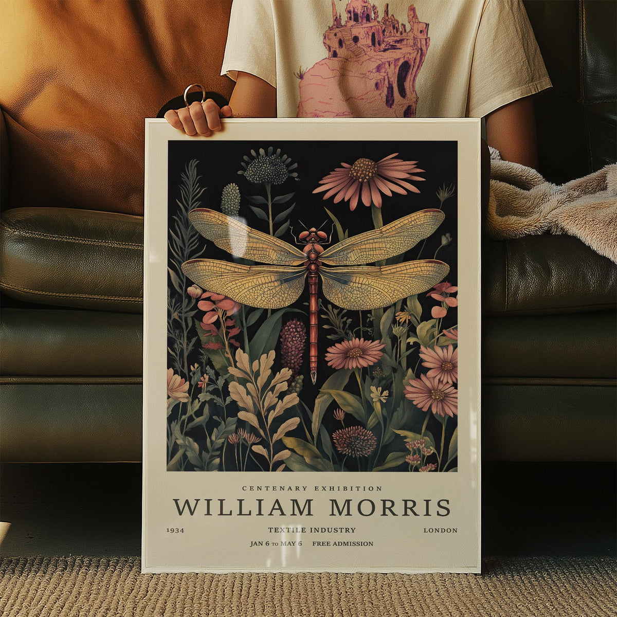 Framed Dragonfly Art Prints with a large golden dragonfly over dark floral background held on a sofa