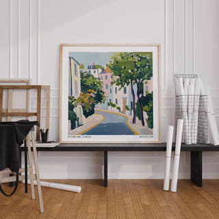 Notting Hill Poster print leaning on a shelf with black fabric and rolled paper in a white walled room