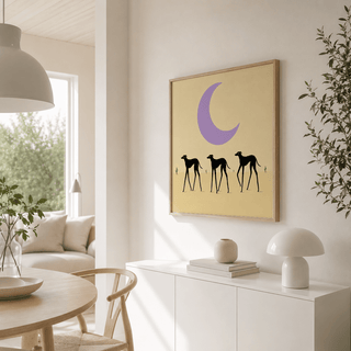 Black dog art print of three black greyhounds under a large purple moon on a pale background in a living room