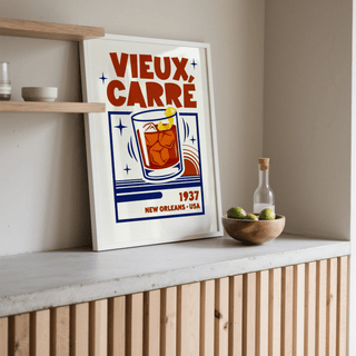 New Orleans Cocktail Print leaning on a surface with a wooden bowl of limes nearby