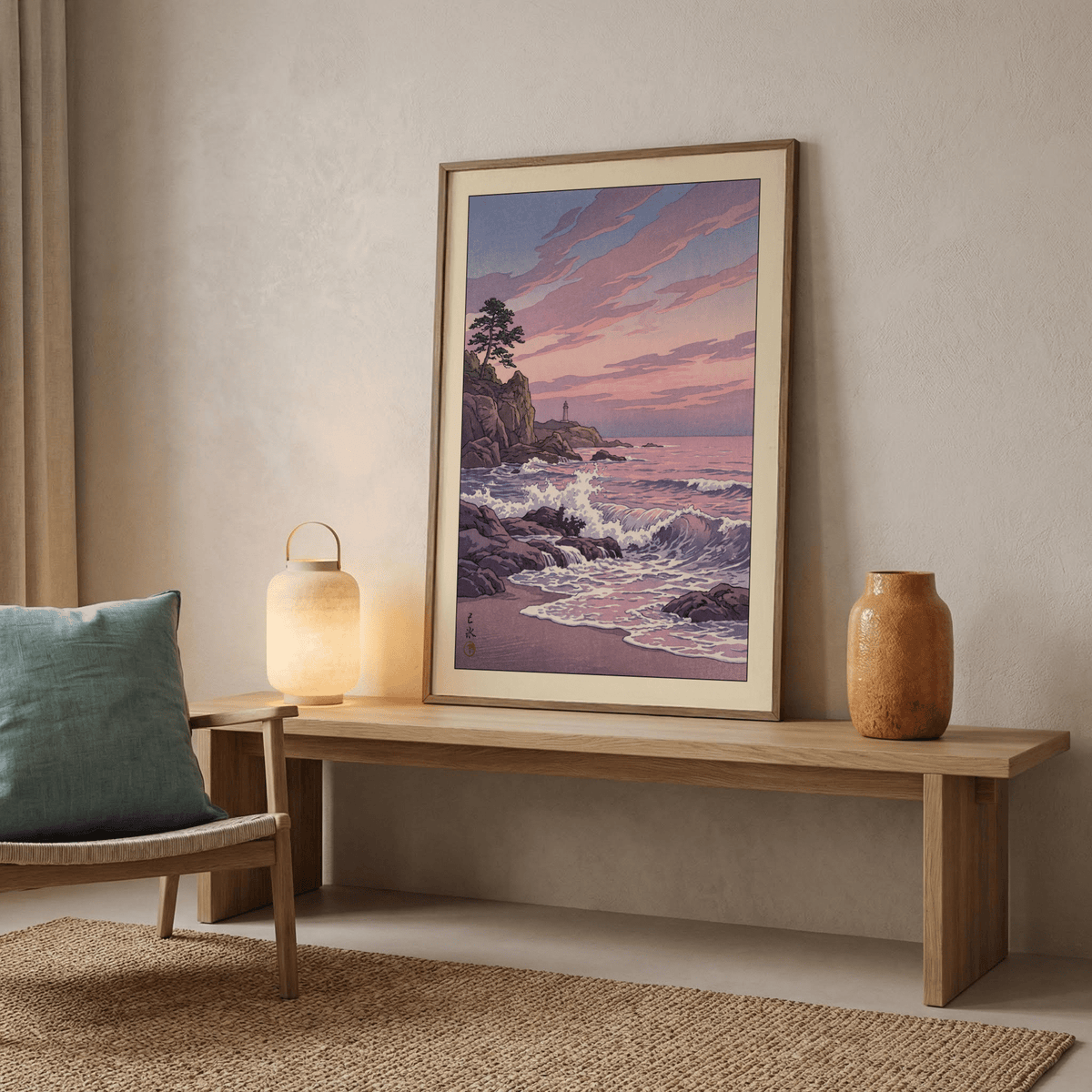 Lighthouse Sunset wall art leaning on a wooden bench with a lamp and vase nearby