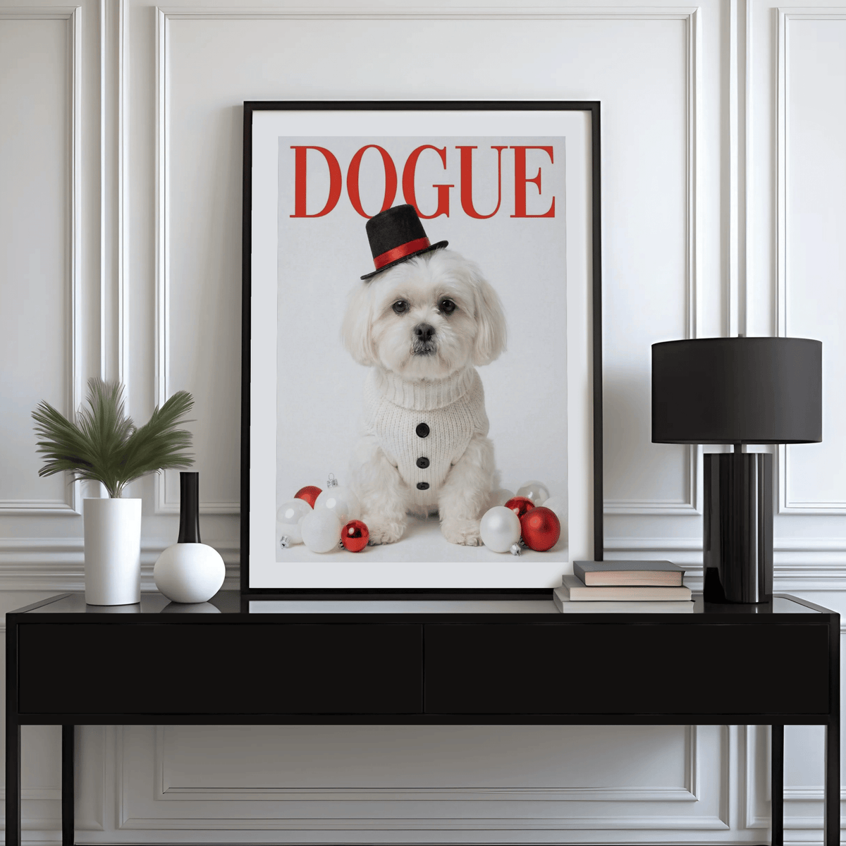 Print on a wall in a room of a white Shih Tzu dog with Christmas baubles and black hat above a black sideboard