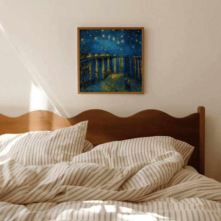 Impasto wall art of a night sky with stars over water above a wooden bed headboard