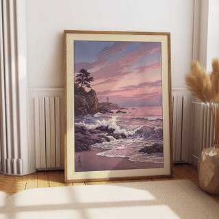 Lighthouse Sunset wall art leaning on a floor with decorative dried plants nearby