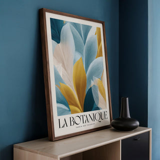 Wall Art Blue and Gold framed print leaning on a sideboard with a black vase nearby