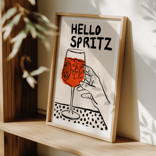 Spritz Print leaning on a shelf with dappled sunlight casting shadows and leafy plant in view