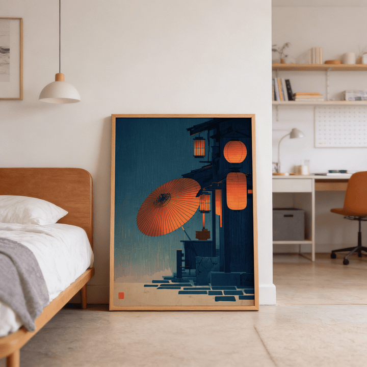 Print leaning on the floor of Japanese Night Scene wall art with red paper lanterns in a minimalist bedroom