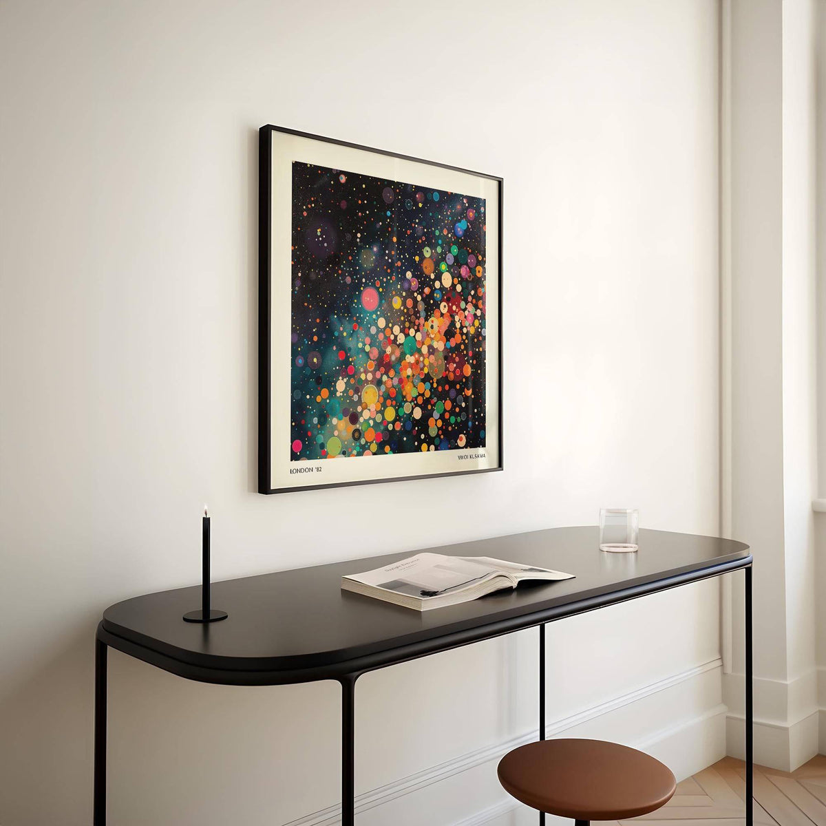Framed Galaxy Posters print with colourful circles above a slim table with a book and glass